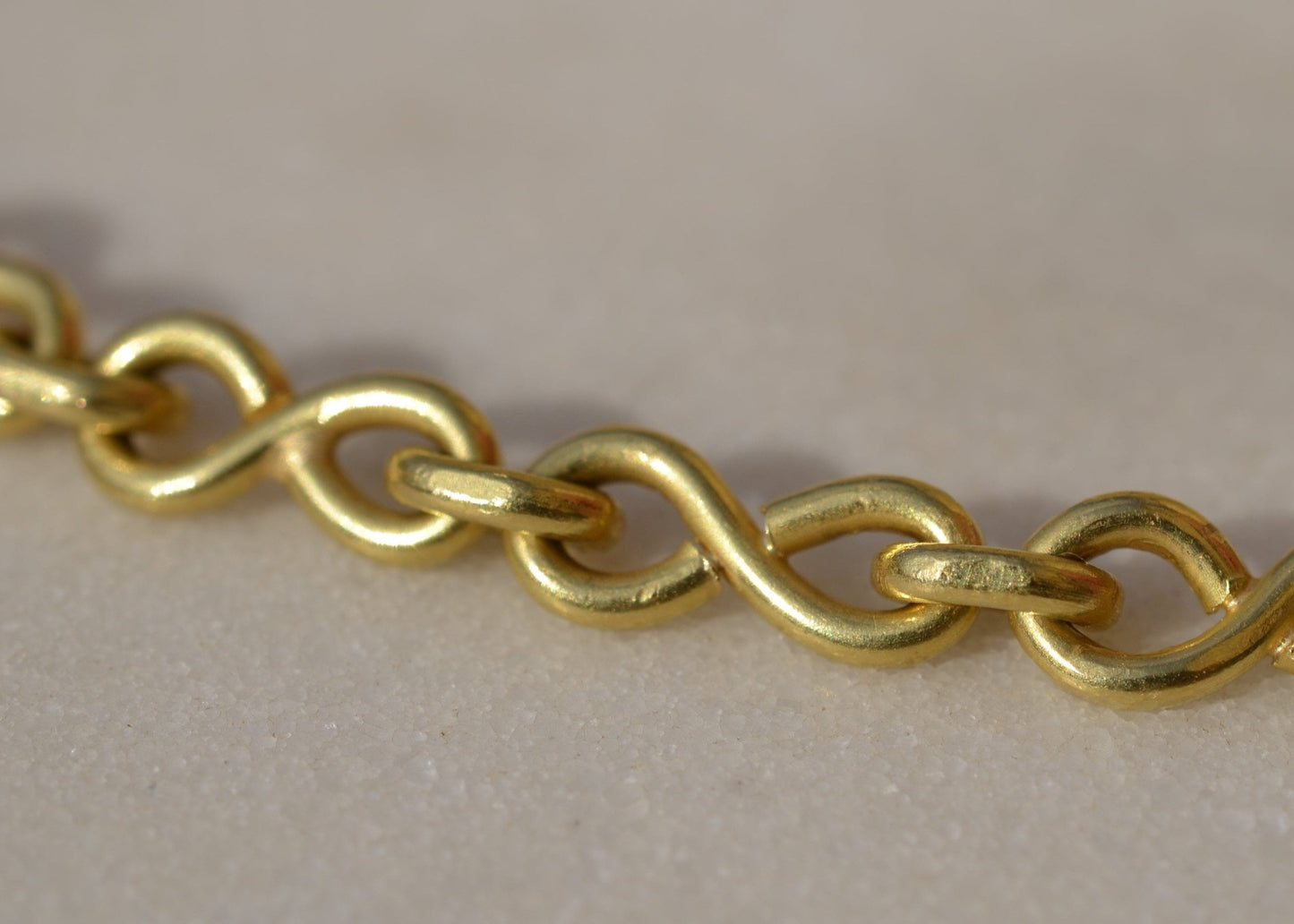 Close-up of a gold chain on marble