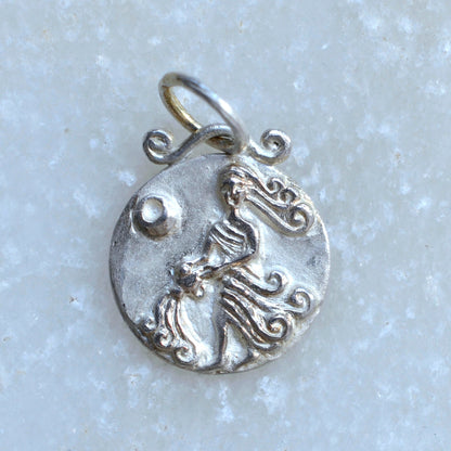 Aquarius zodiac pendant in silver on marble