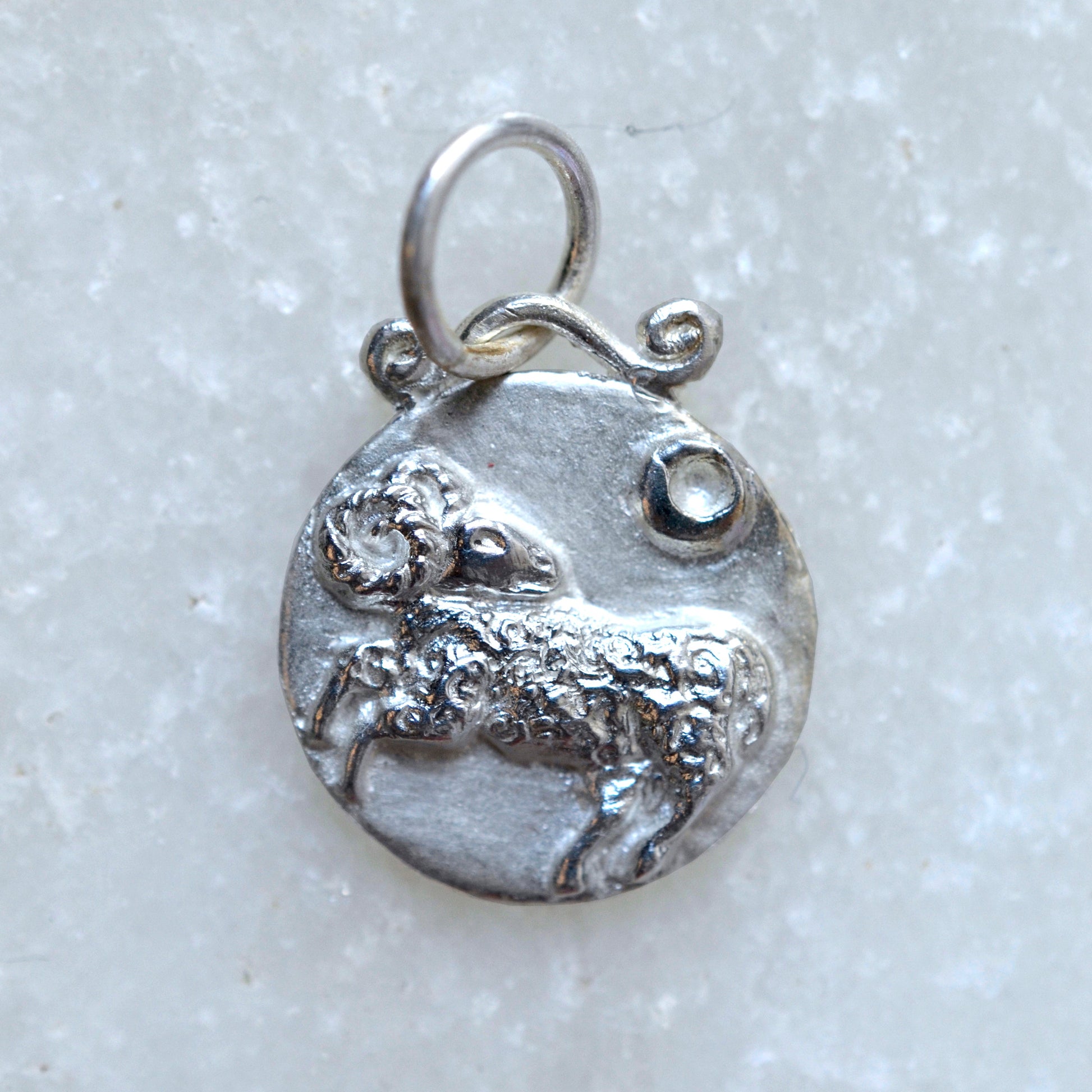 Aries zodica pendant in silver on marble