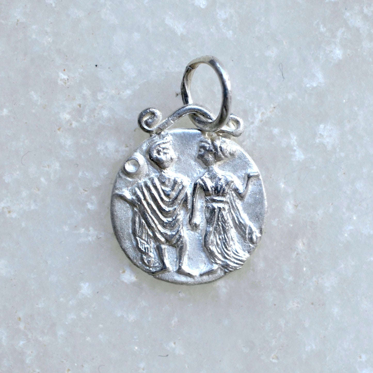 Gemini zodiac pendant in silver on marble