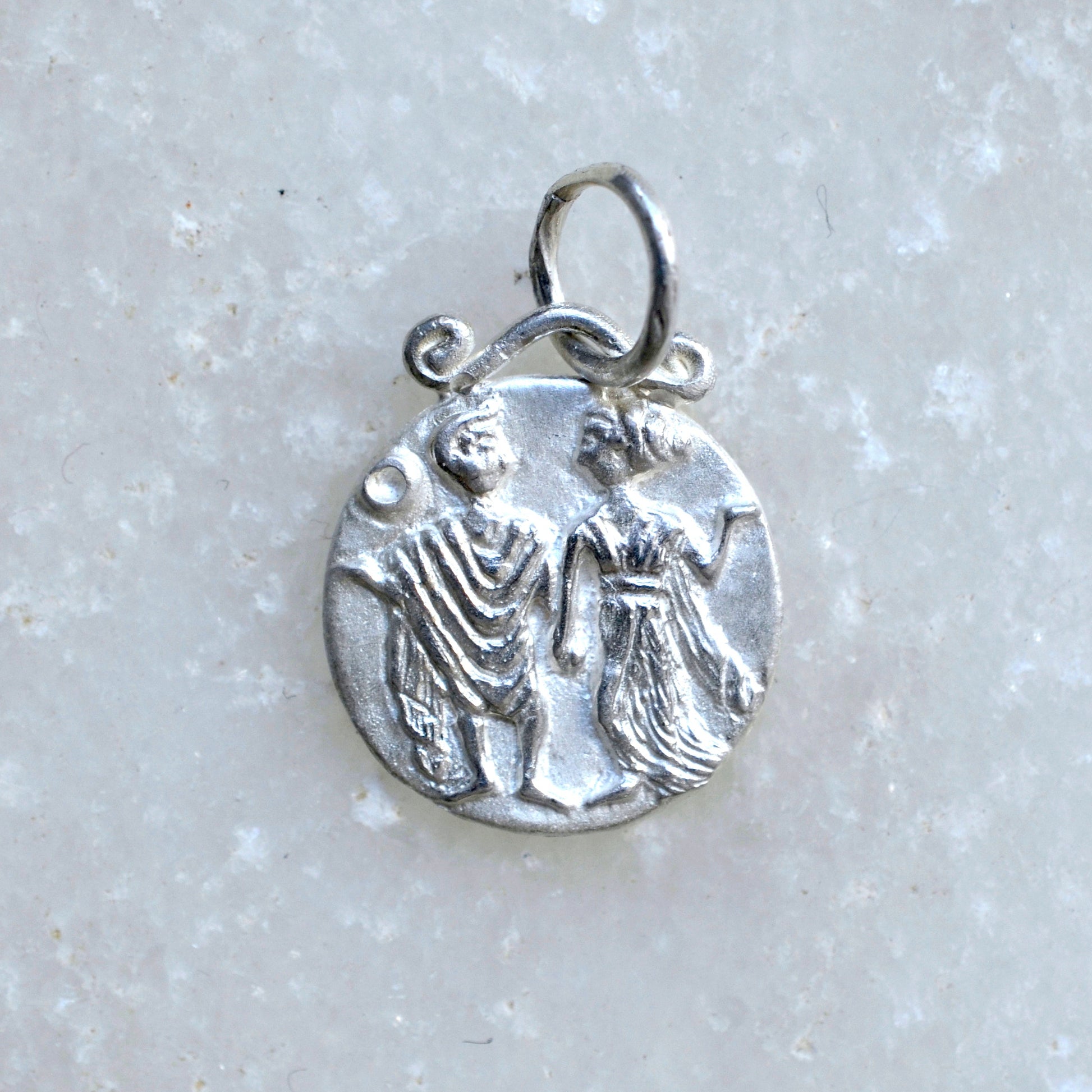 Gemini zodiac pendant in silver on marble