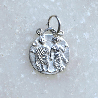 Gemini zodiac pendant in silver on marble