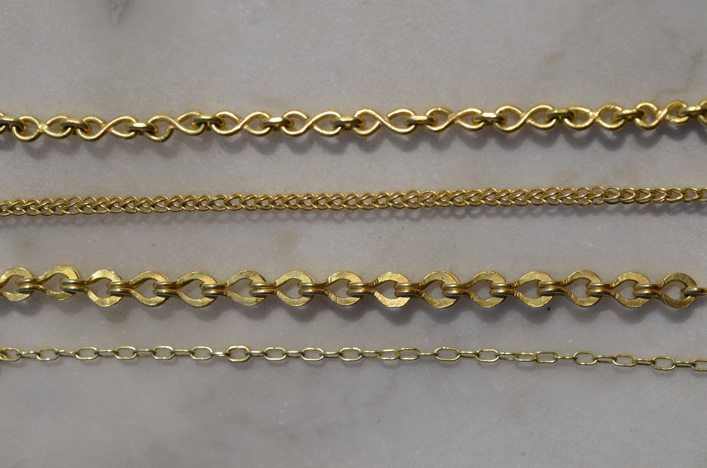 Four types of handmade chains: the infinity loop, the loop-in-loop classic, the loop-in-loop Roman and  the paperlink chain.
