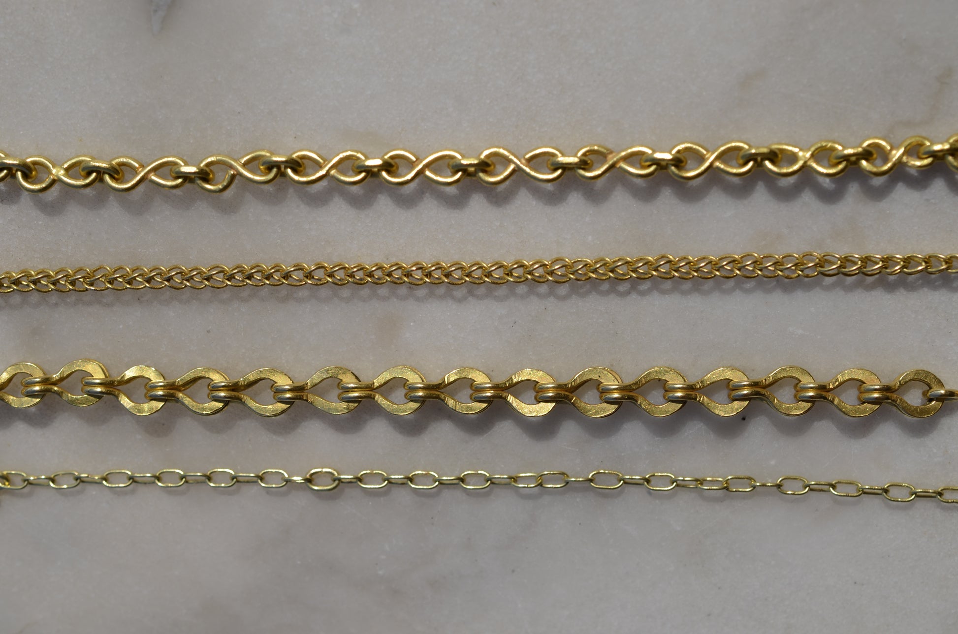 Four types of handmade chains: the infinity loop, the loop-in-loop classic, the loop-in-loop Roman and  the paperlink chain.