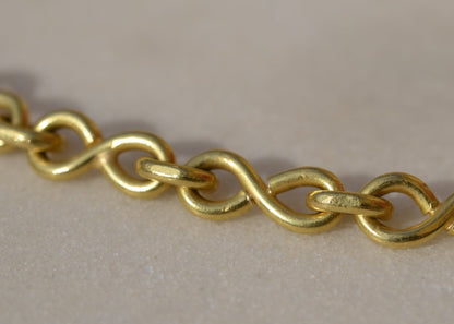 Close-up of a gold chain on marble