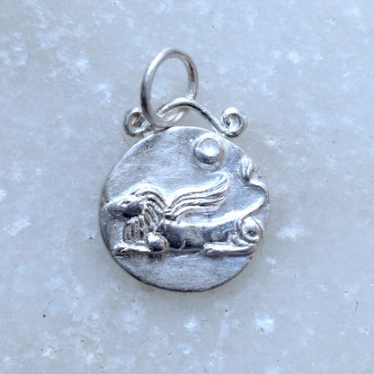Leo zodiac pendant in silver on marble