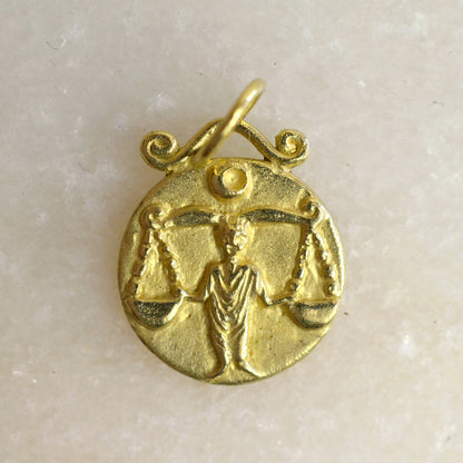 Libra zodiac pendant in 18 karat gold on marble