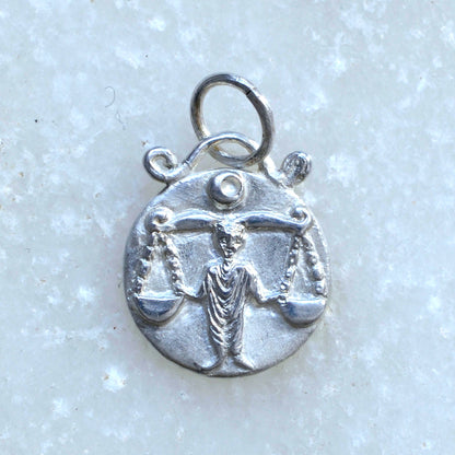 Libra zodiac pendant in silver on marble