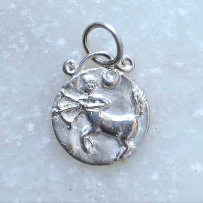 Sagittarius zodiac pendant in silver on marble