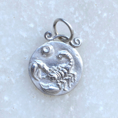Scorpio zodiac pendant in silver on marble