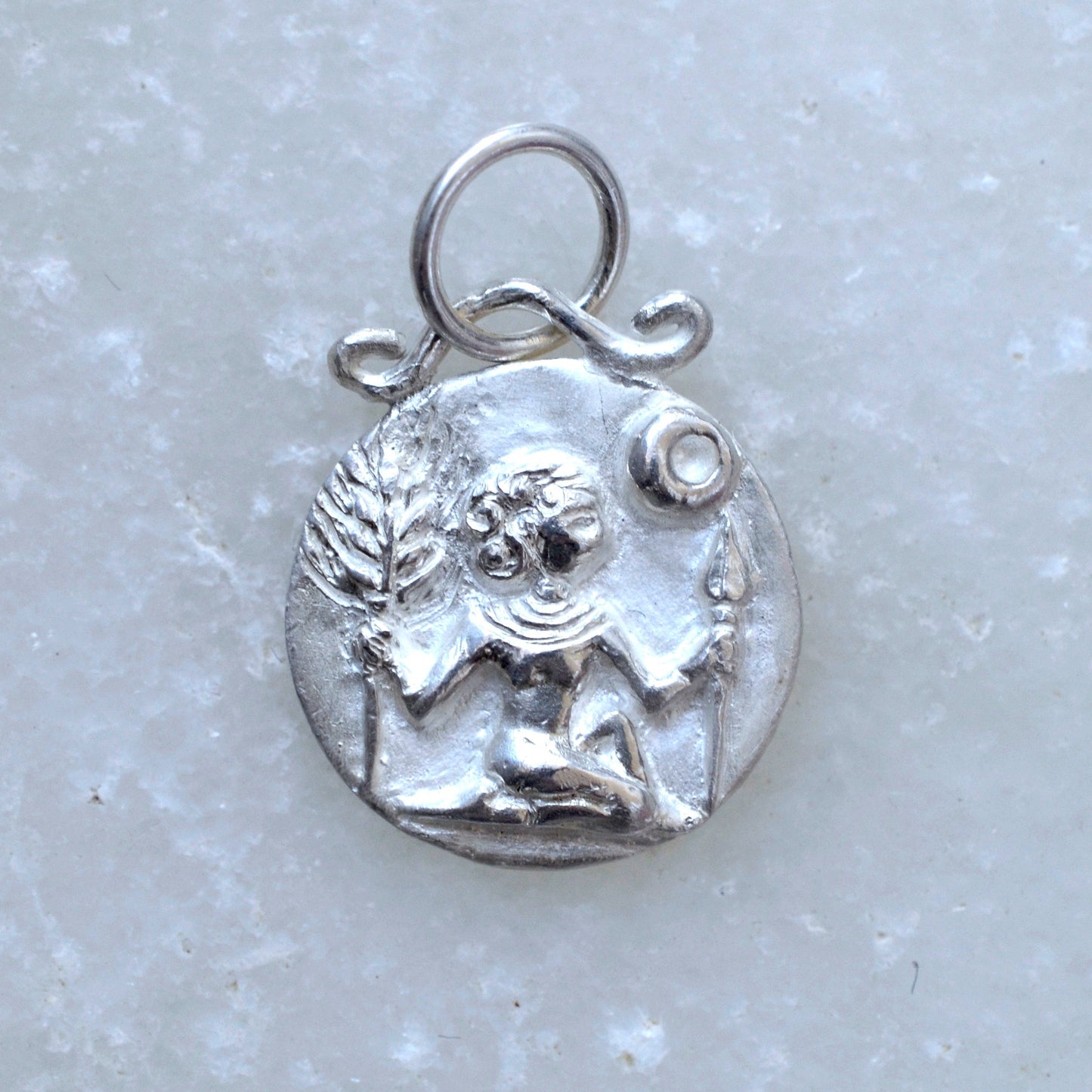 Virgo zodiac pendant in silver on marble