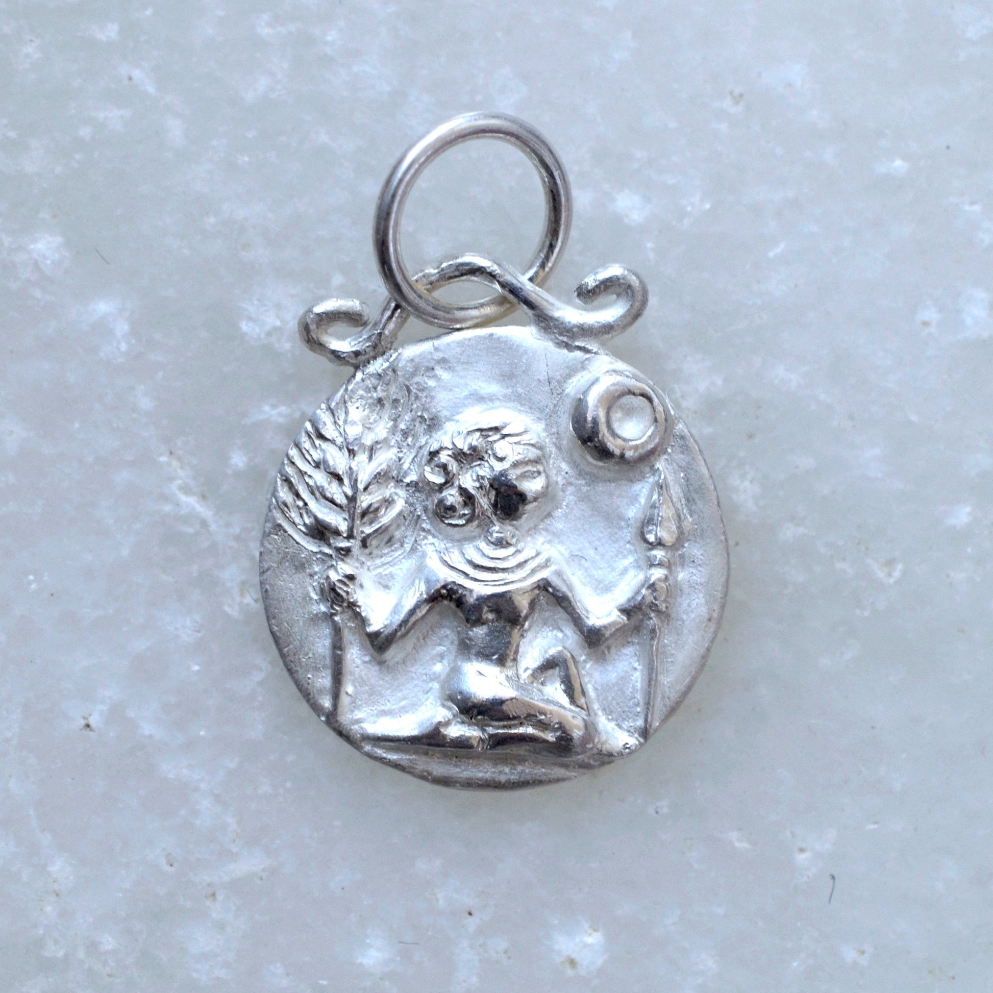 Virgo zodiac pendant in silver on marble