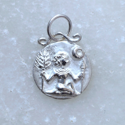 Virgo zodiac pendant in silver on marble