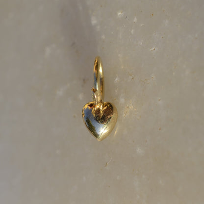 heart shaped gold pendant on marble