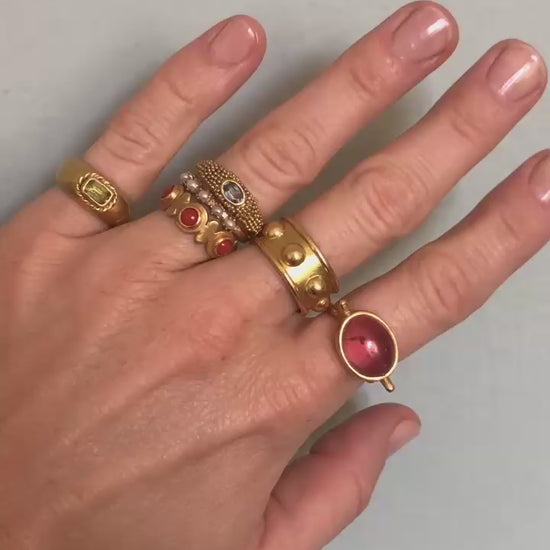 hand wearing gold rings moving